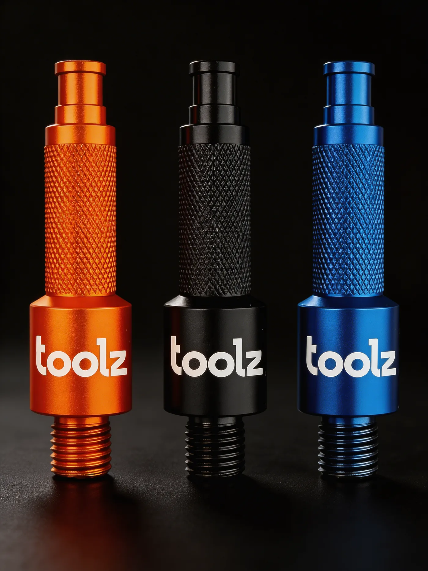 Three Oil Drain Tools side by side in orange, black and blue